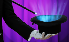 magician holding a magic top hat and wand