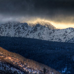 clouds over a snowy mountain range